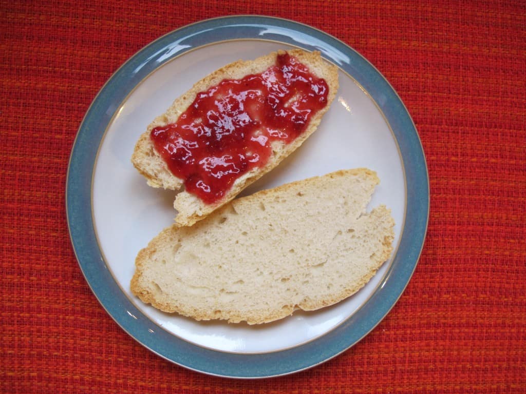 White spelt bread with strawberry jam Slices of white spelt bread with strawberry jam